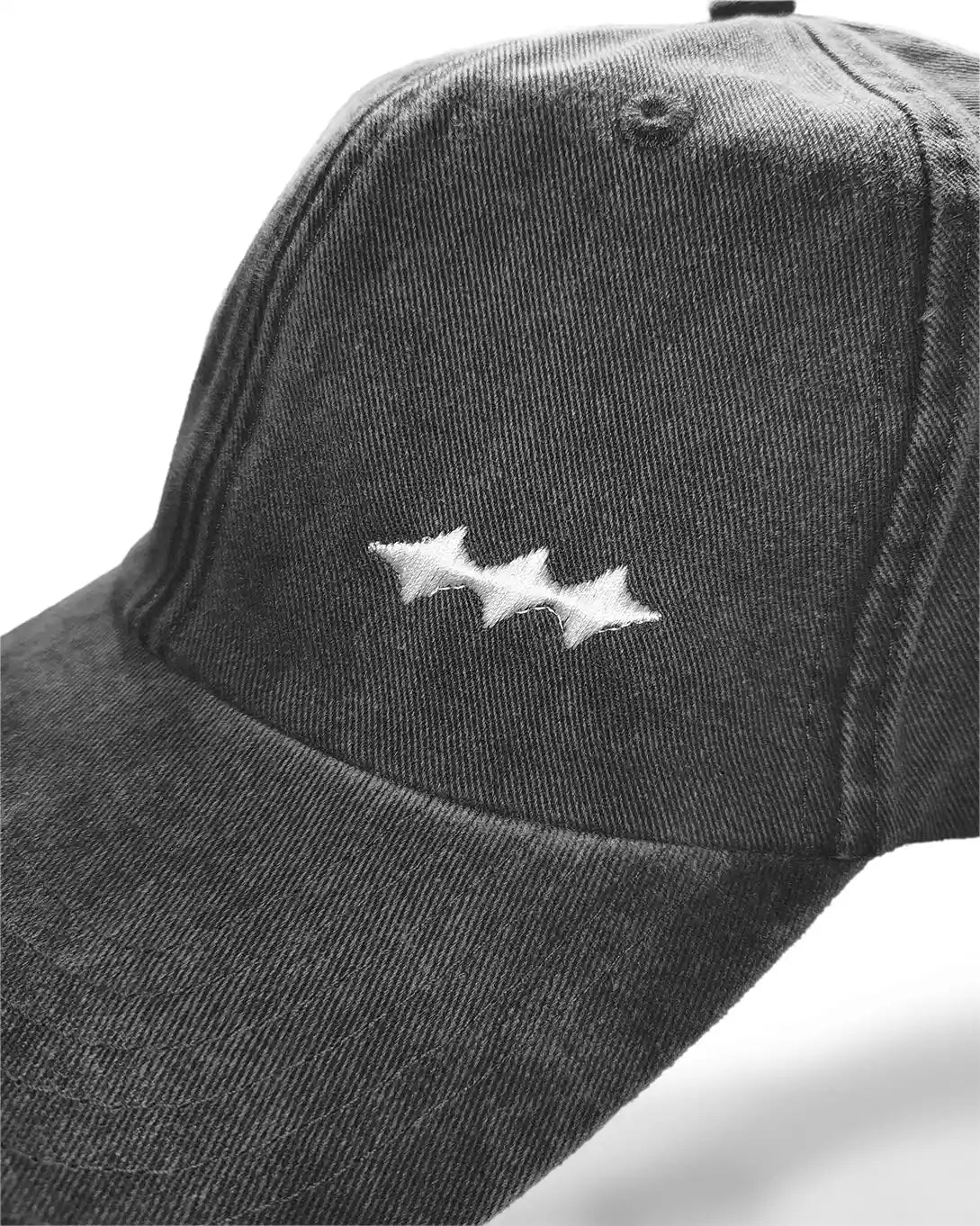 A close-up of a dark gray washed cotton baseball cap featuring a white embroidered logo of three connected stars on the front panel.